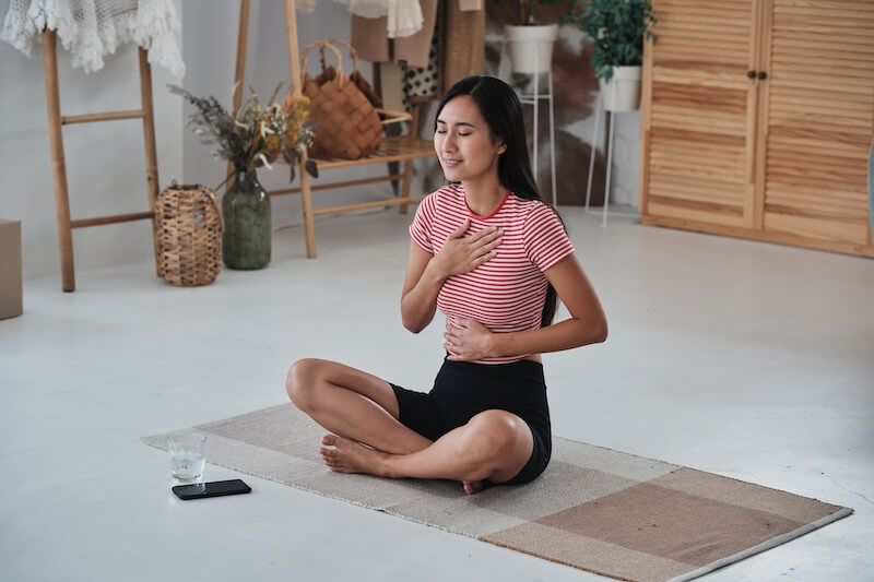 A user practicing Diaphragmatic Breathing while sitting